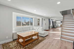 Living room with light hardwood / wood-style floors