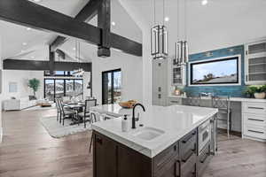 Kitchen shot showing prep sink and proximity to dining area and living area.