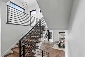 Stairs with hardwood flooring and steel railings.