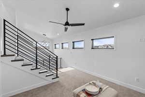 Another angle of the loft showing stairs to 2nd Primary bedroom and window views.