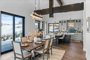 Dining area featuring hardwood flooring, beams and view front side sliding door