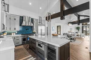 Another angle of the kitchen showing the beverage fridge and microwave.