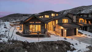 Exterior space with a mountain view, a garage, and covered deck