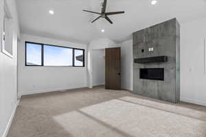 2nd primary bedroom featuring large windows, fireplace and carpet.