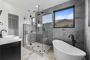 2nd primary bathroom with large tub, walk in shower and large window.