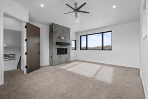 2nd primary bedroom featuring large windows, fireplace and carpet.