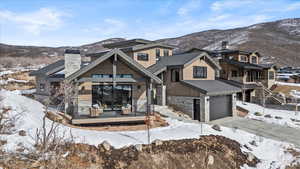 View of front of house featuring a deck, a garage, and a mountain view