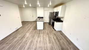 Kitchen featuring white cabinetry, appliances with stainless steel finishes, sink, and light hardwood / wood-style flooring