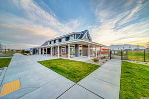 Farmhouse inspired home featuring a yard and covered porch