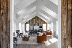 Living room with high vaulted ceiling and light wood-type flooring