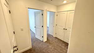 Hallway with dark carpet