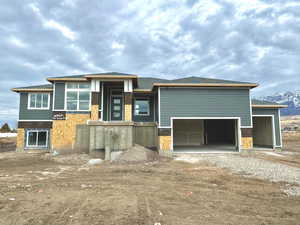 View of front of property with a mountain view and a garage