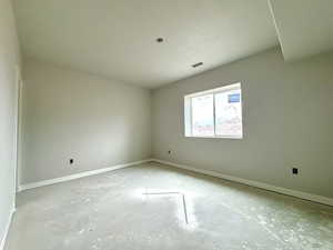 Unfurnished room featuring a textured ceiling