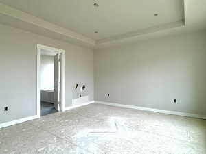 Unfurnished room with a tray ceiling