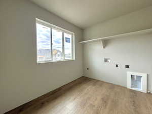 Laundry area featuring hookup for a washing machine and light hardwood / wood-style flooring