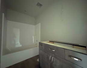 Bathroom featuring wood-type flooring and shower / bath combination