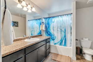 Full bathroom featuring vanity, toilet, and shower / bath combo