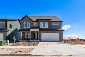 Traditional home with driveway and an attached garage