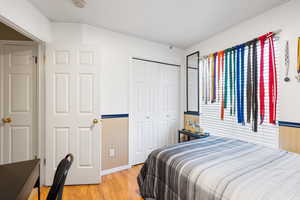 Bedroom featuring light hardwood / wood-style floors and a closet