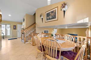 Tiled dining space with vaulted ceiling