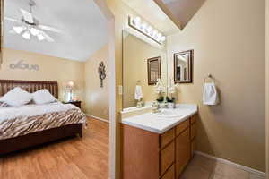 Interior space featuring sink, light tile patterned floors, and vaulted ceiling