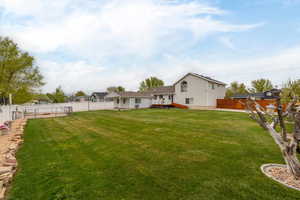 View of yard with a fenced backyard and a wooden deck