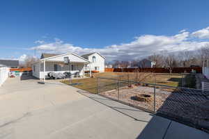 View of front of property with covered porch and a front lawn