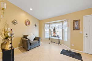 Entrance foyer with lofted ceiling and light tile patterned floors