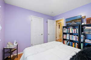 Bedroom featuring wood-type flooring