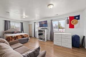 Bedroom with light wood-type flooring and visible vents