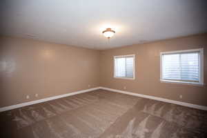 Unfurnished room with carpet