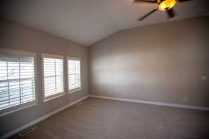 Master Suite featuring lofted ceiling, carpet floors, and ceiling fan