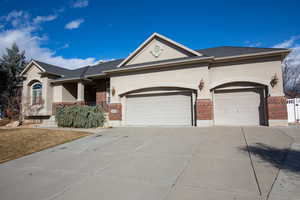 Single story home featuring a 3-car garage and large side gate.