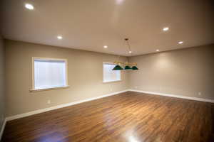 Game room with dark hardwood / wood-style floors