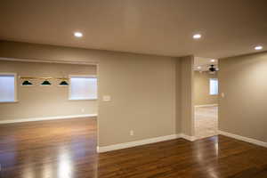 Game room with dark hardwood / wood-style floors and ceiling fan