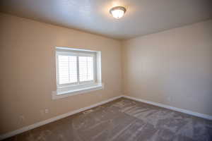 Bedroom #2 featuring dark colored carpet