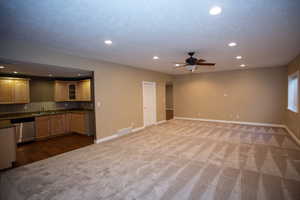 Family room featuring ceiling fan, sink, and carpet