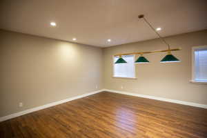 Game room featuring dark wood-type flooring