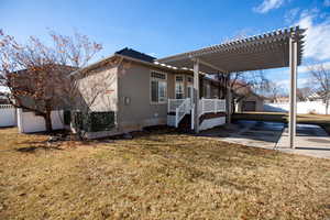 View of property exterior with a pergola and a spacious lawn