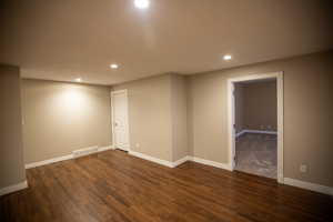 Flexible space featuring dark hardwood / wood-style floors