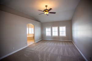 Master Suite with vaulted ceiling, light carpet, ceiling fan and plantation shutters