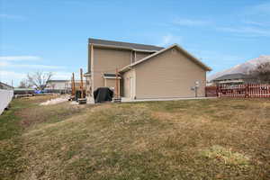 Back of house featuring a yard