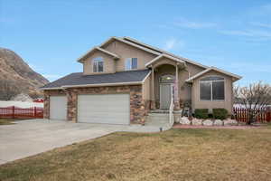 View of front of house with a garage and a front lawn