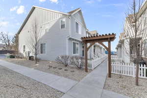 View of property exterior featuring a pergola