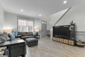 Living room with light hardwood / wood-style floors