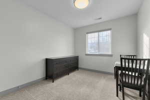 Living area with light colored carpet