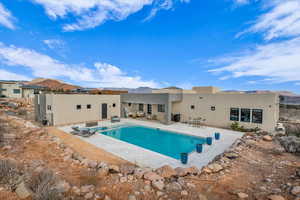 View of pool with a patio and a mountain view