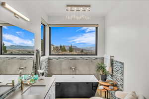 Bathroom featuring vanity, a mountain view, an inviting chandelier, and a bathtub