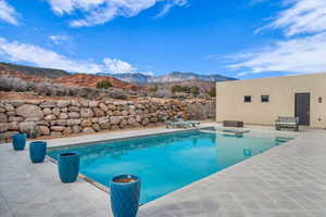 View of pool featuring a mountain view and a patio