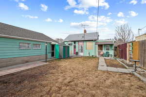 Rear view of house with a yard